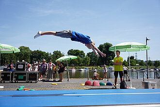 Ein Junge spricht auf einer Airtrack.